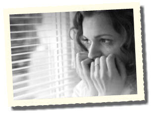Woman with social anxiety looking out of window